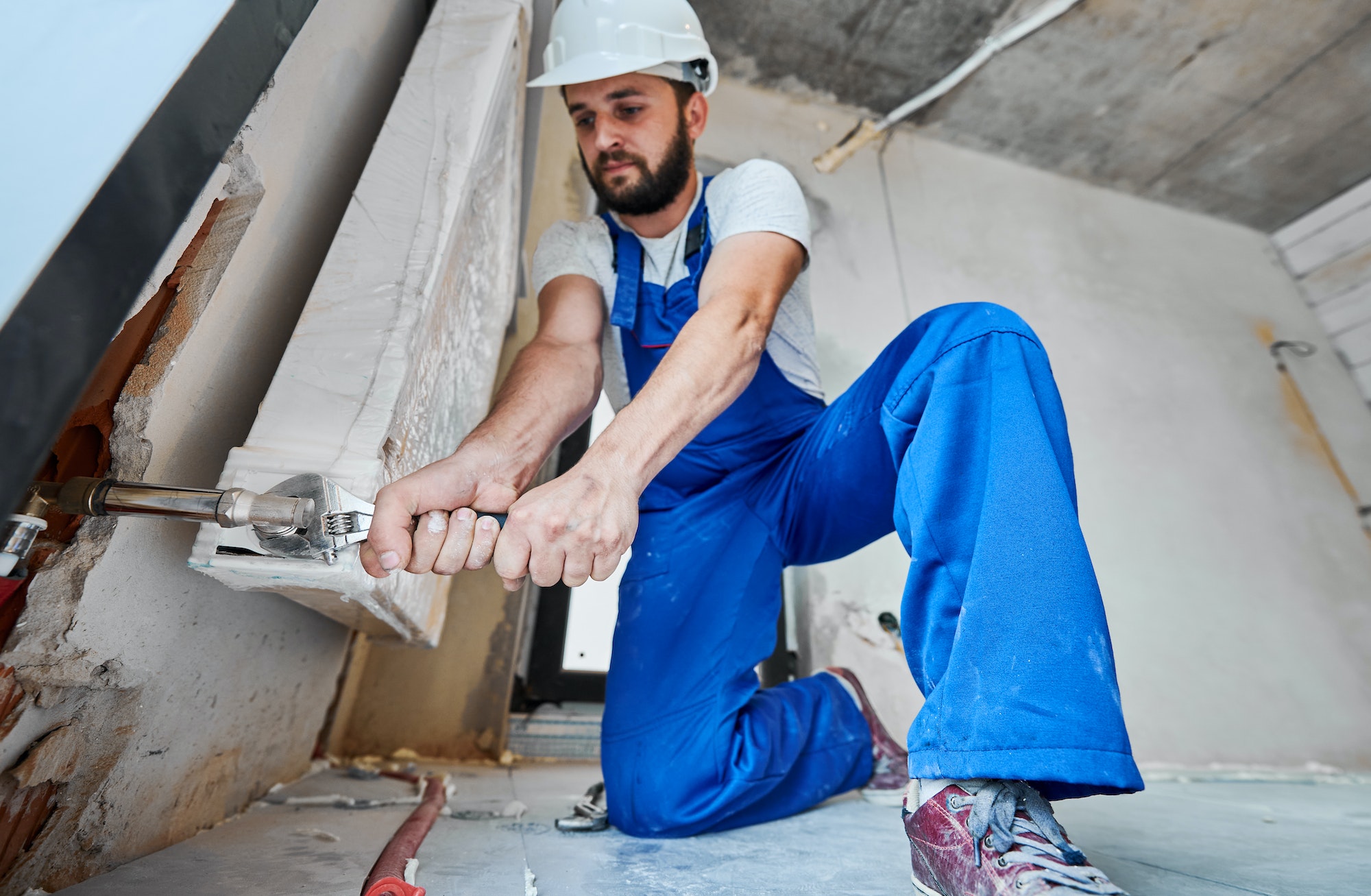 plumber-screwing-plumbing-fittings-with-a-wrench.jpg